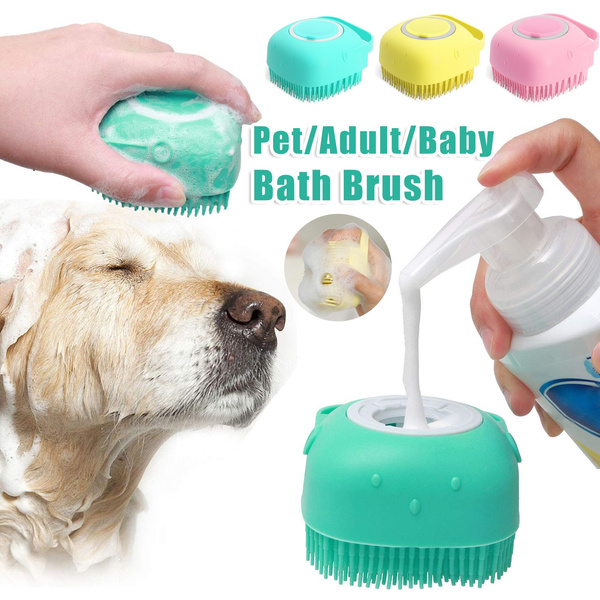 Silicone bath brush being filled with shampoo, used on a golden retriever